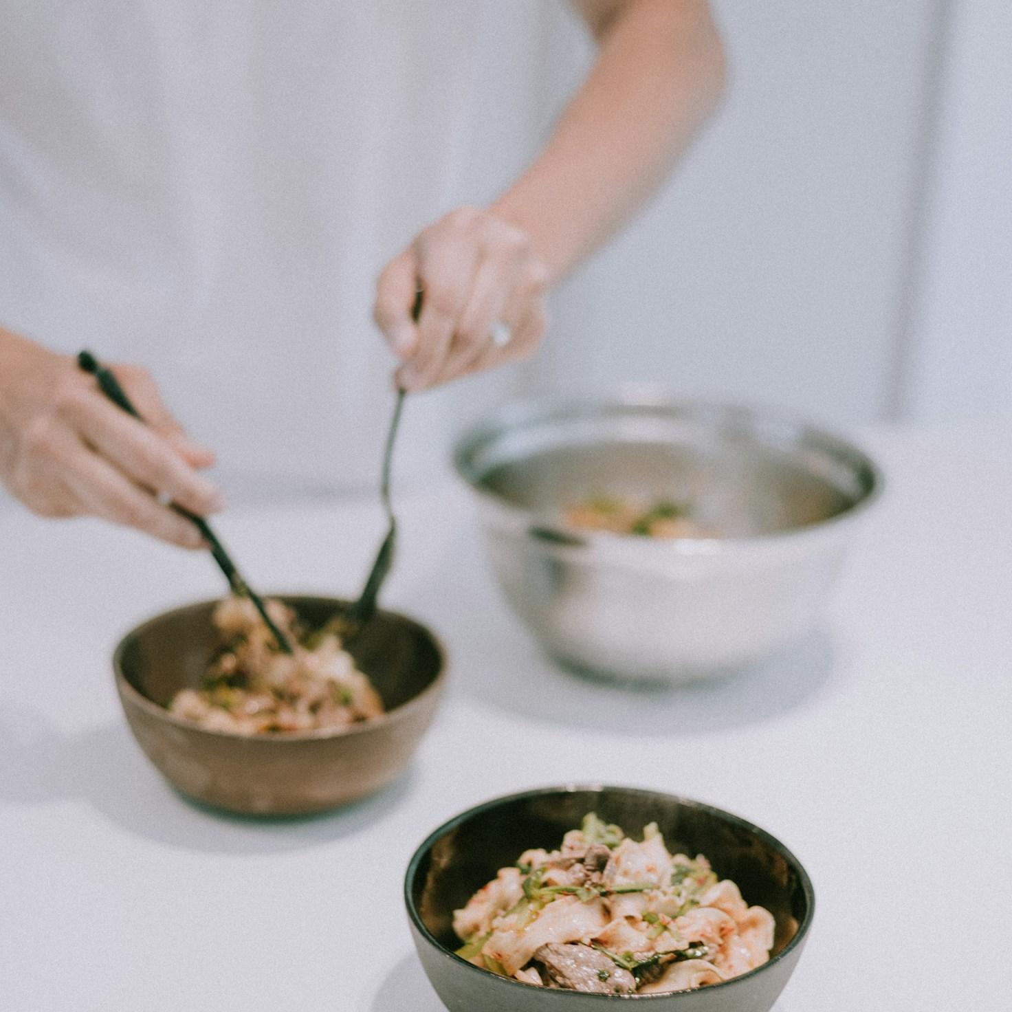 Diverse group of community members sharing a meal together, showcasing the social bonds formed through collaborative cooking